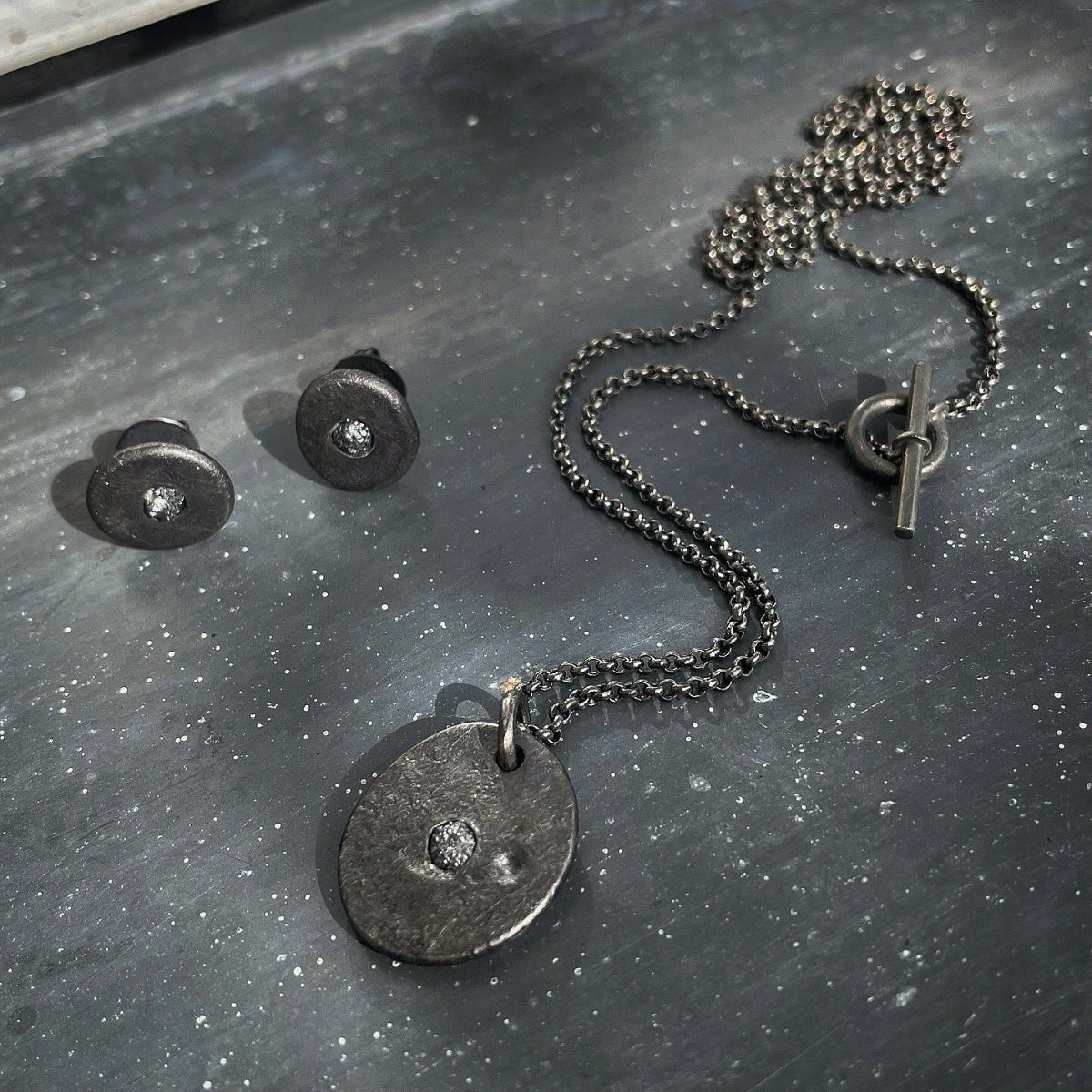 Blackend silver necklace and earrings with raw black diamonds