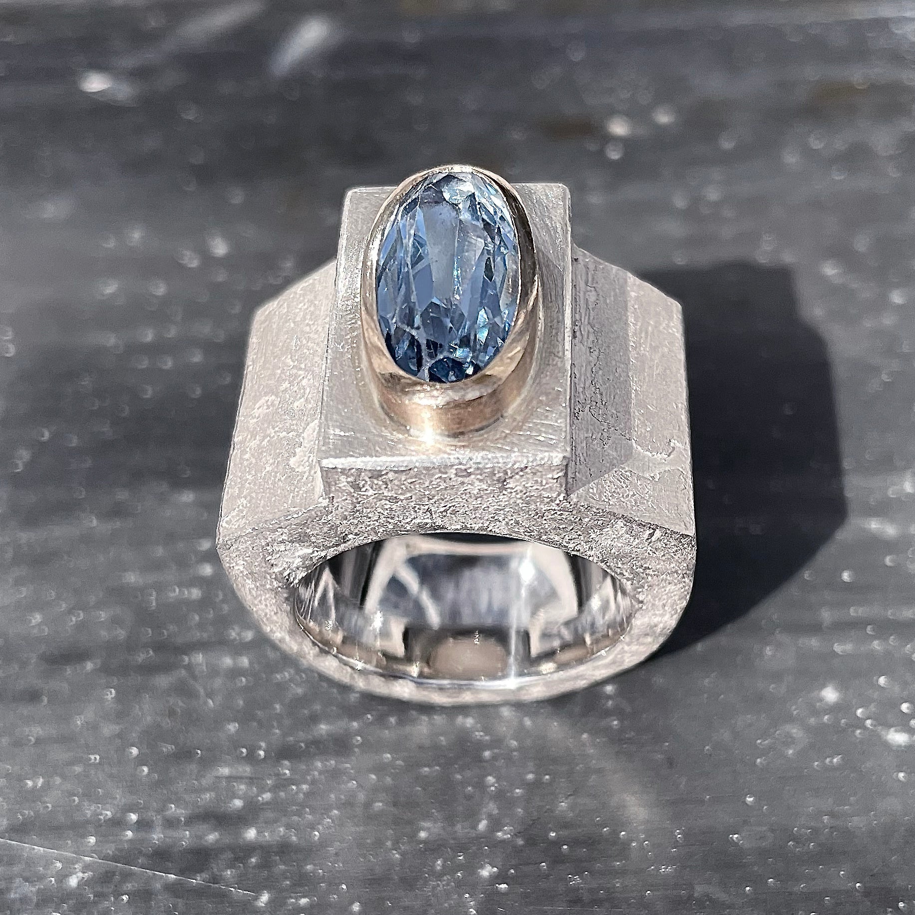 Silver ring with aquamarine in gold setting