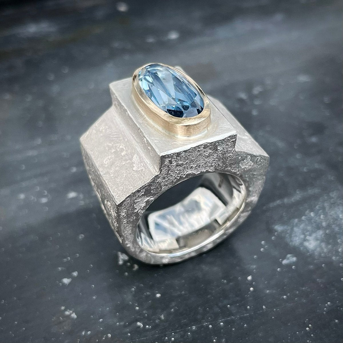 Silver ring with aquamarine in gold setting
