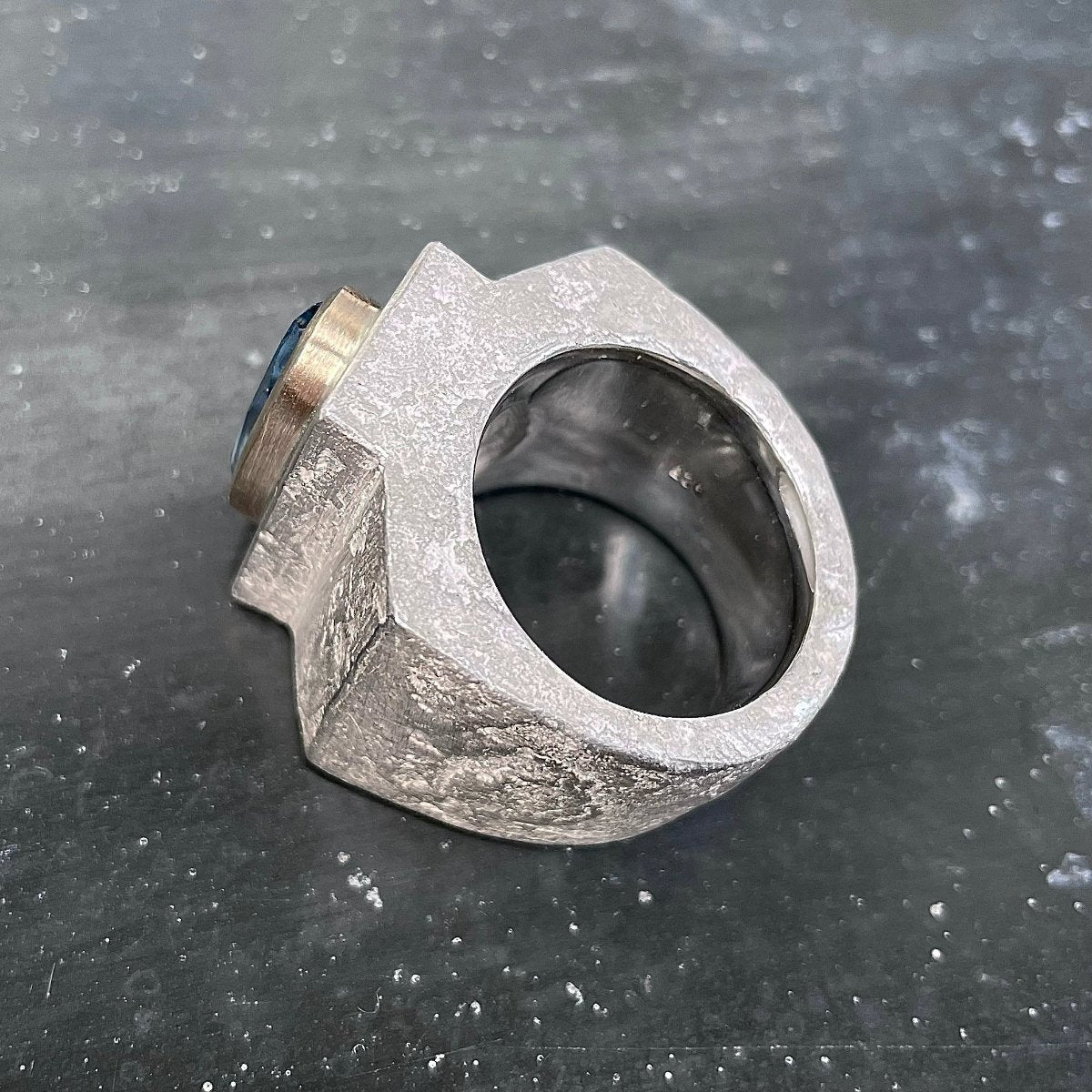 Silver ring with aquamarine in gold setting side view