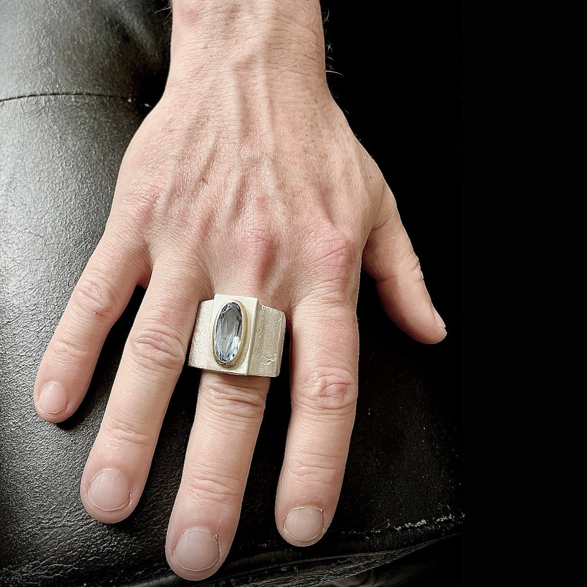 Silver ring with aquamarine in gold setting worn