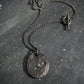 Oxidised silver necklace with a round pendant with raw black diamond