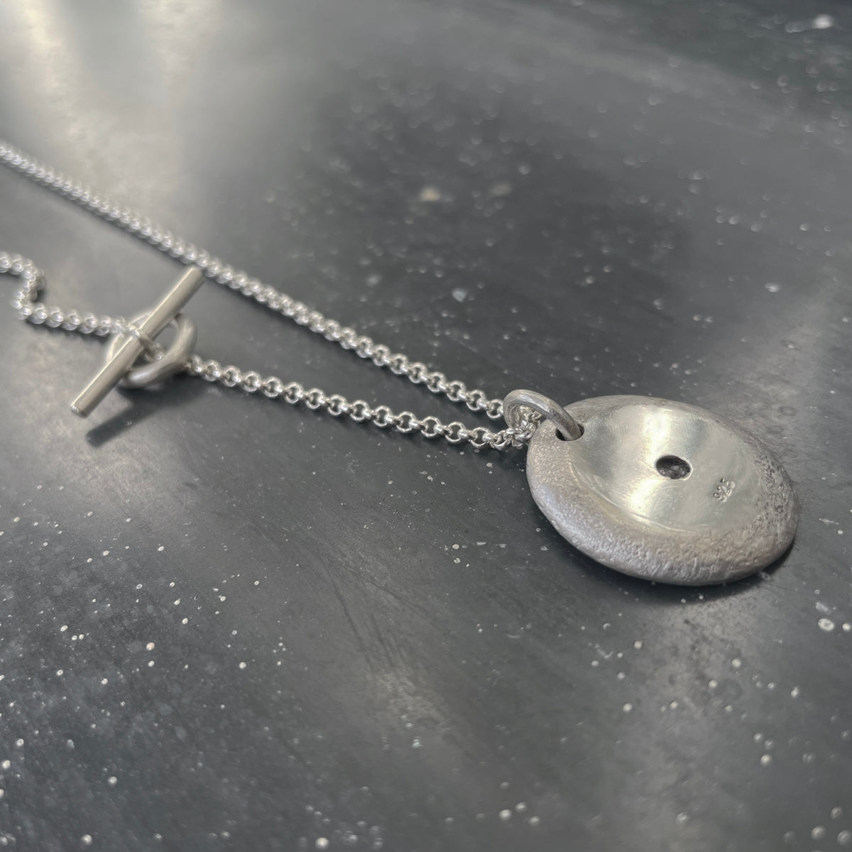 Dot necklace silver with raw black diamond back side